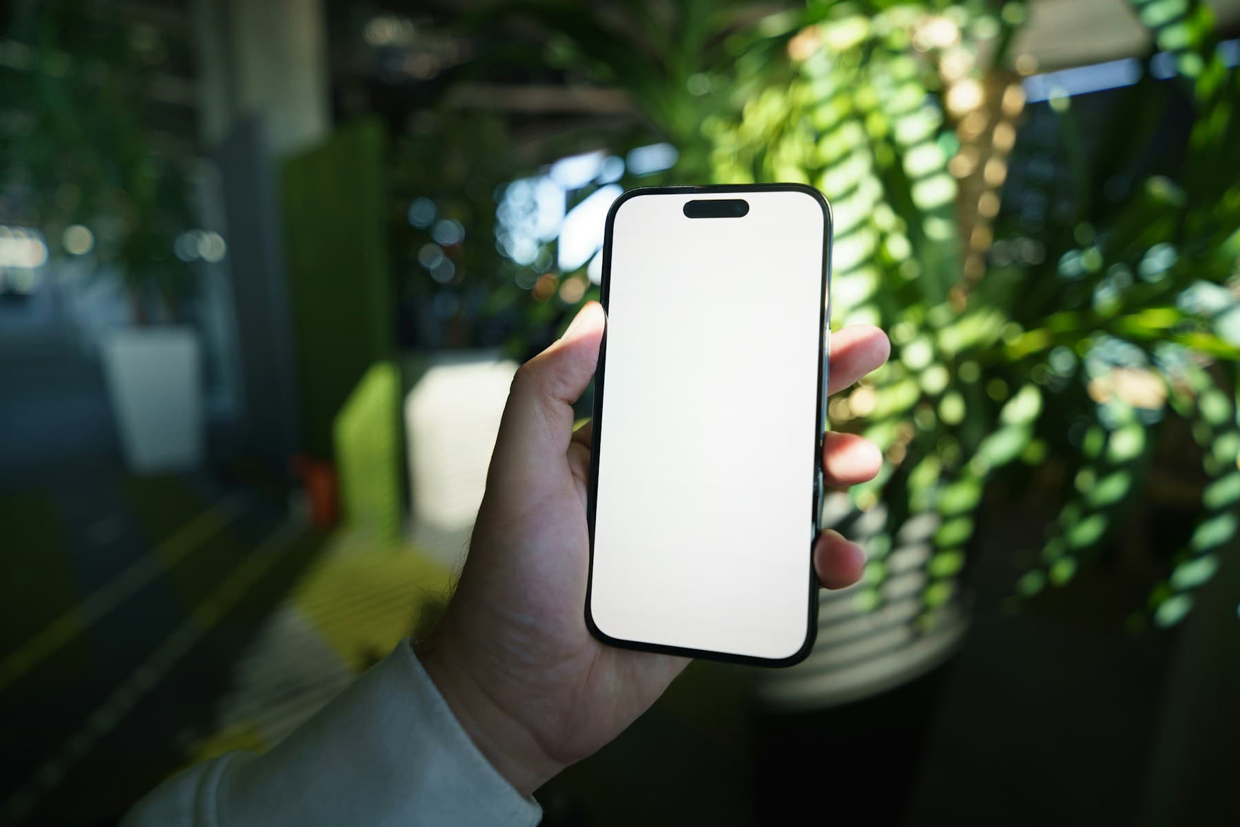 Smartphone mockup in hand with green background light